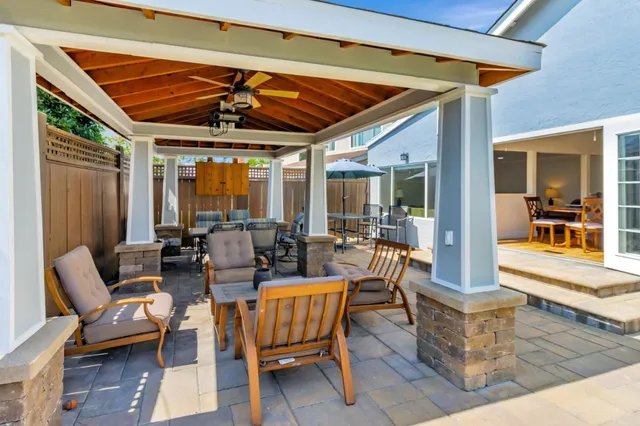 a view of a lounge chairs in back yard of the house