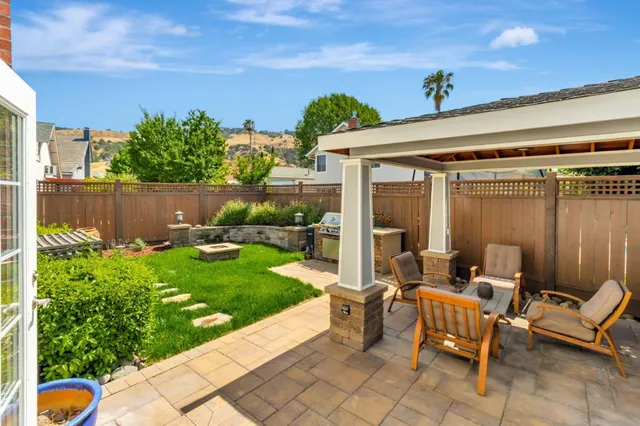 a view of a backyard with plants and a patio