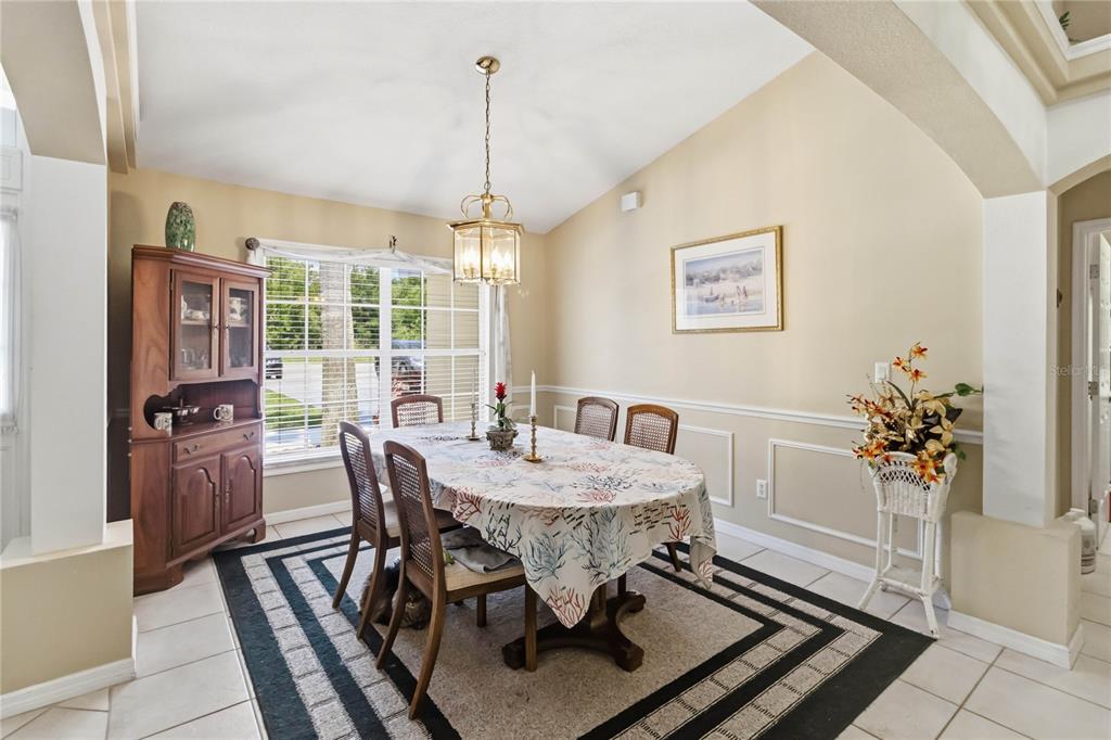 3225 Canoe Creek Road St. Cloud, FL 34772 - Photo 7 of 30 a view of a dining room with furniture window and wooden floor