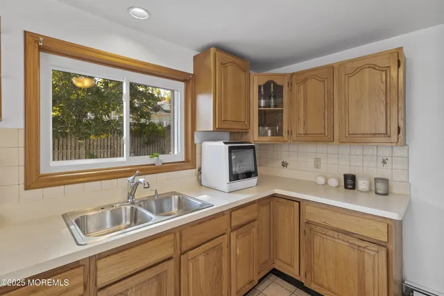 a kitchen with stainless steel appliances a sink a stove and cabinets