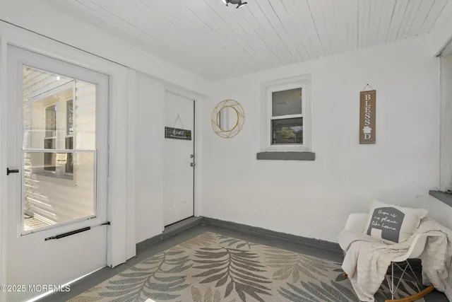 a view of room with window and hardwood floor