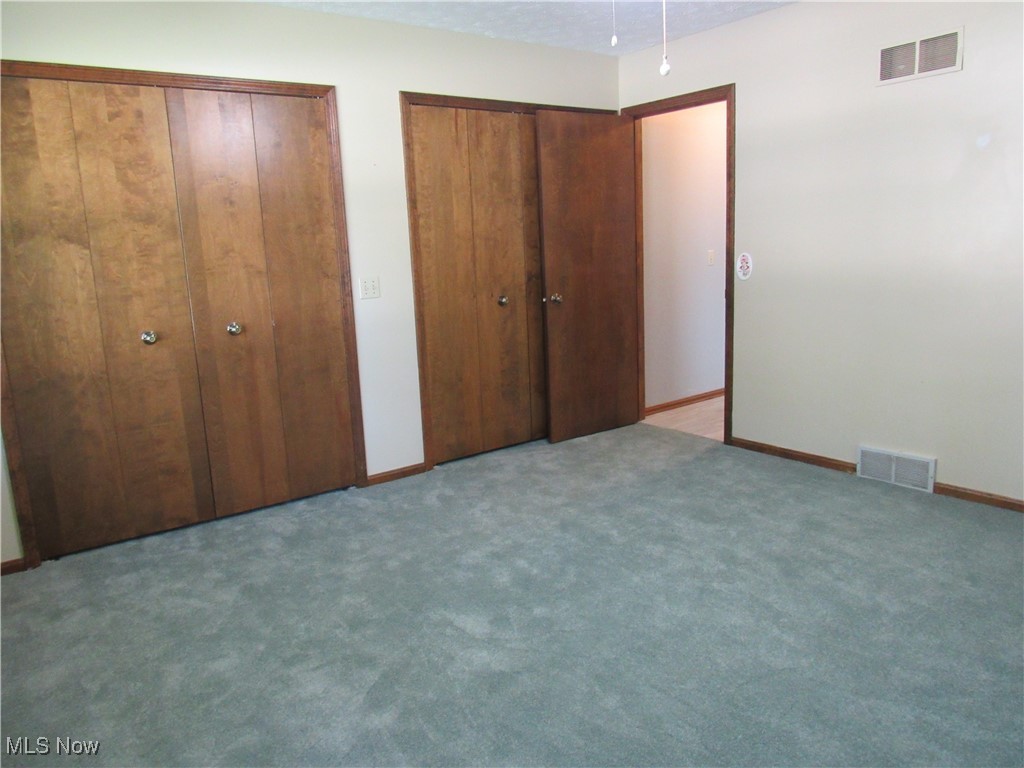 1120 Vincent Road Southeast North Canton, OH 44720 - Photo 40 of 50 Front bedroom with double closets and new carpet flooring