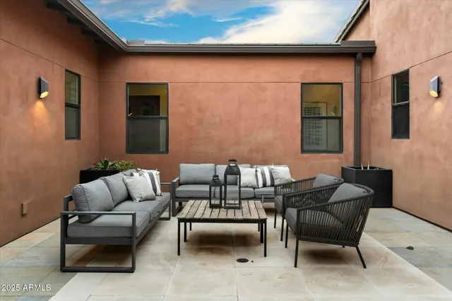a living room with furniture and kitchen view