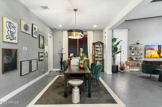 a living room with furniture flat screen tv and a large window