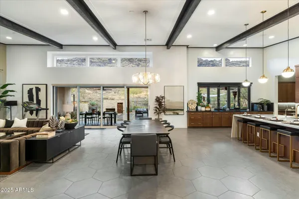 a kitchen with kitchen island a large counter top space and stainless steel appliances