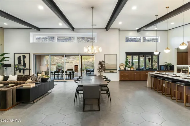 a kitchen with kitchen island a large counter top space and stainless steel appliances