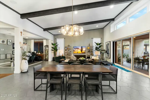 a kitchen with a stove a sink a counter top space and living room view