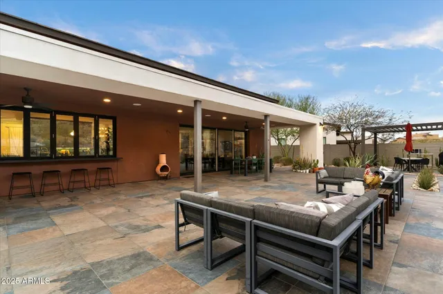 a view of a patio with a table and chairs