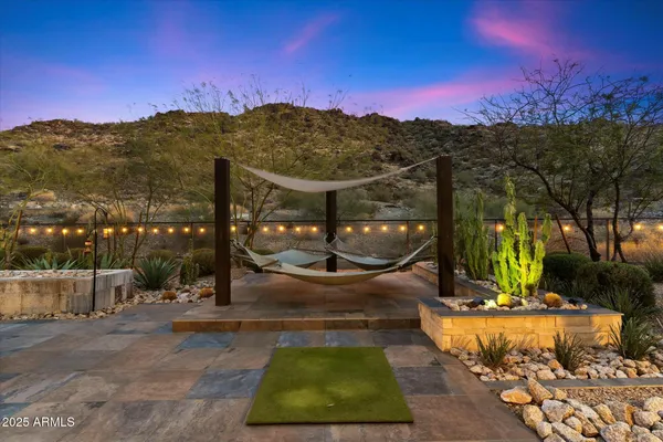 a view of a patio with a table and chairs