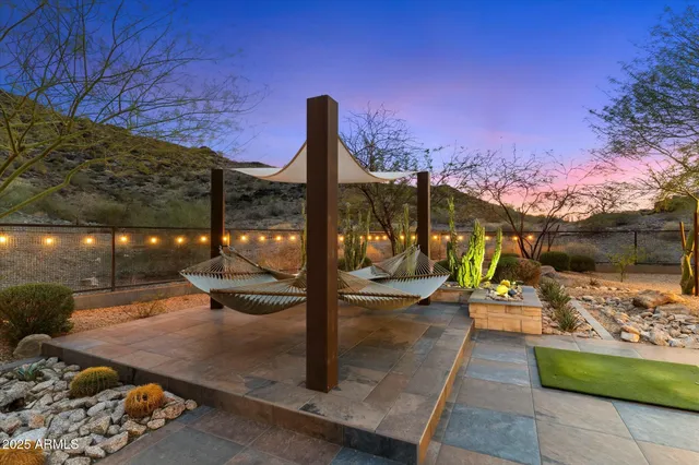 a view of a terrace with couches and a fireplace