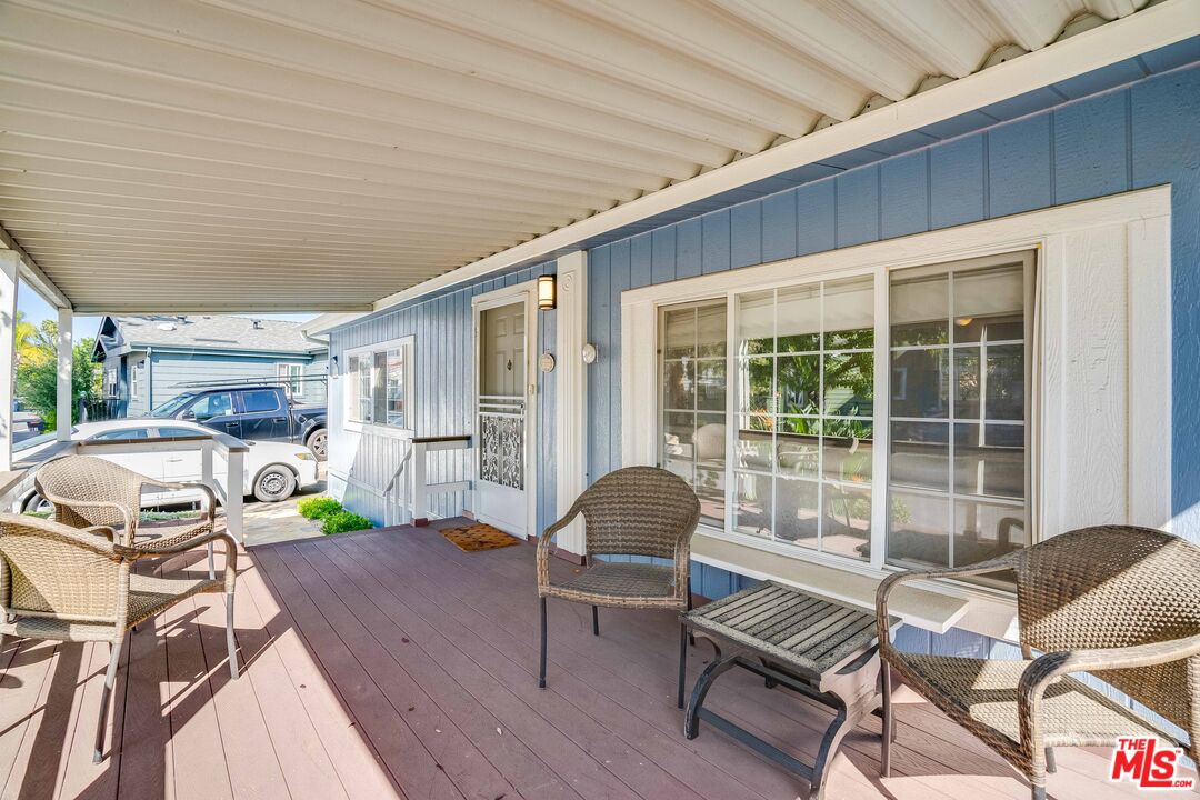 1111 Cherokee Topanga, CA 90290 - Photo 16 of 21 a view of a patio with table and chairs with wooden floor and fence