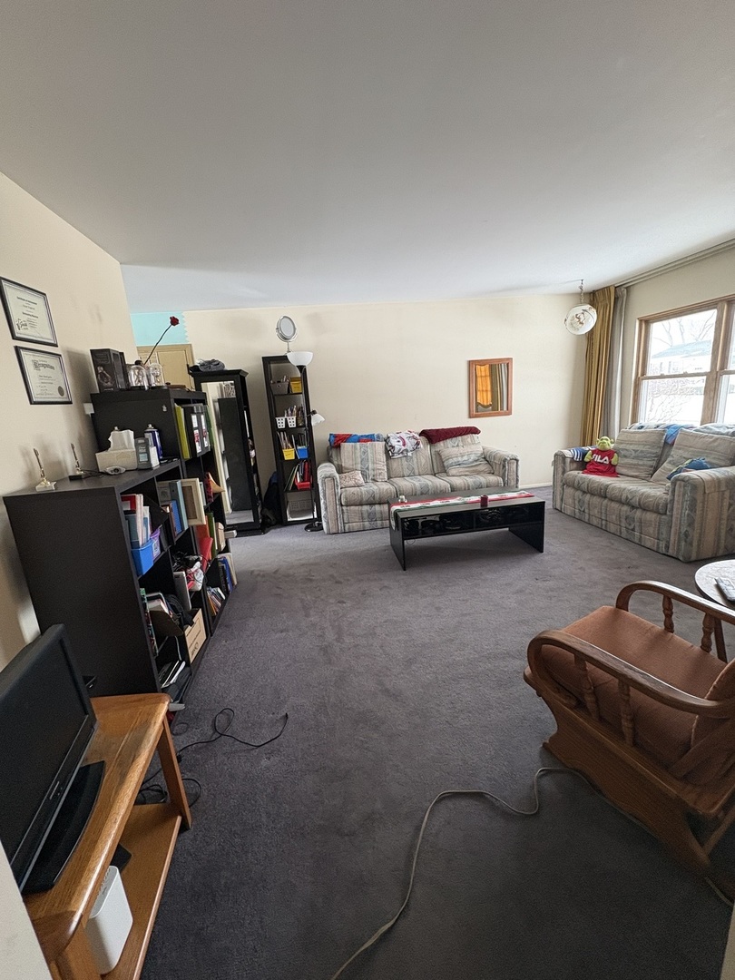 170 Cherrywood Road Buffalo Grove, IL 60089 - Photo 2 of 8 a living room with furniture and a gym cycle