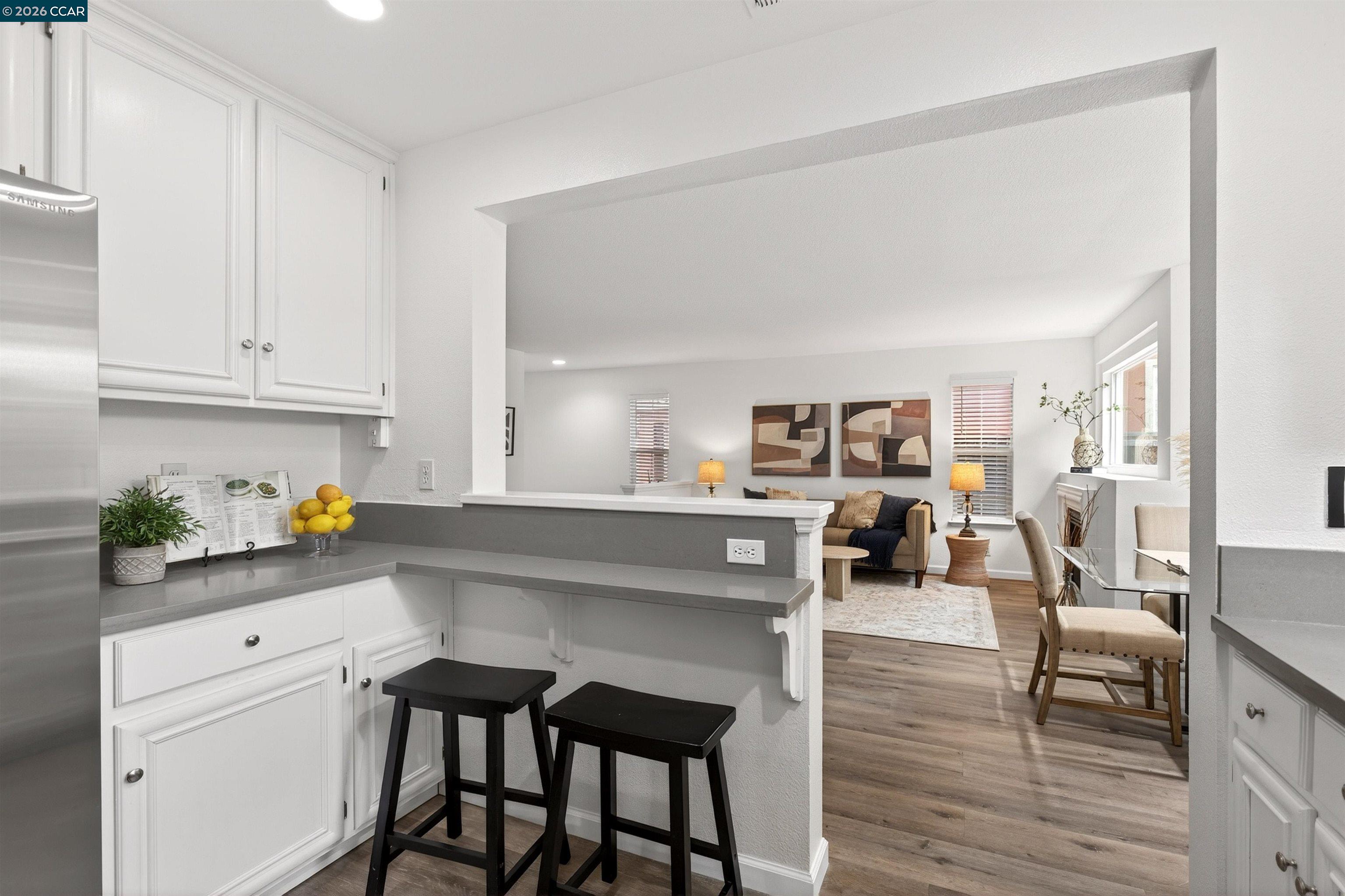 124 Coralflower Lane San Ramon, CA 94582 - Photo 12 of 47 a kitchen with a table chairs refrigerator and cabinets