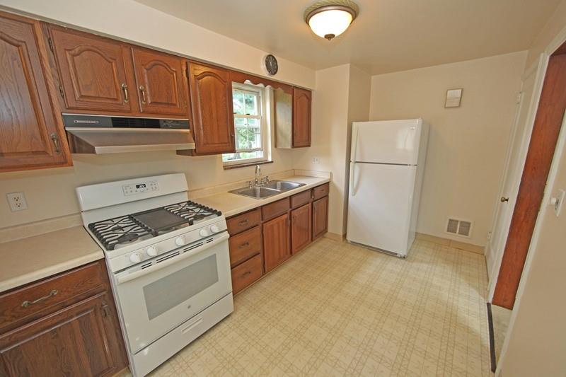 8077 Peebles Road Pittsburgh, PA 15237 - Photo 3 of 9 a kitchen with a stove sink and a refrigerator