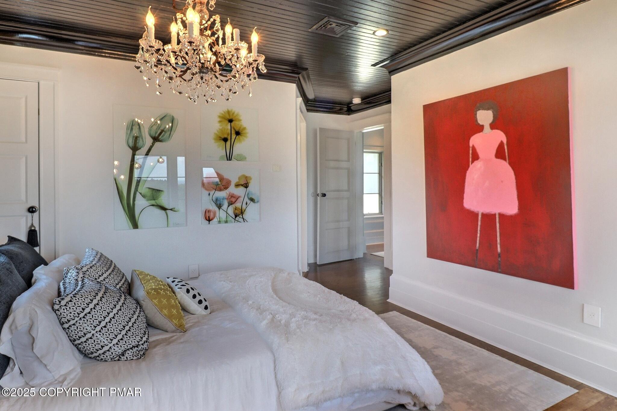 1212 Burger Hollow Road Effort, PA 18330 - Photo 103 of 138 a bedroom with a bed and a chandelier