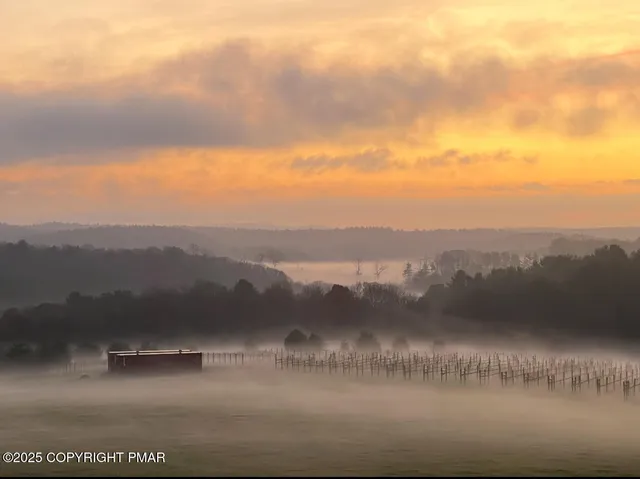 a living room with patio furniture and a chandelier