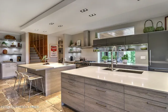 a bedroom with a bed and large windows