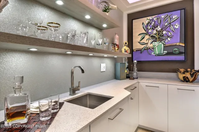 a bedroom with a bed dresser and window