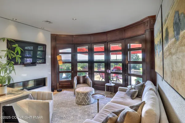 a bedroom with furniture and a large window