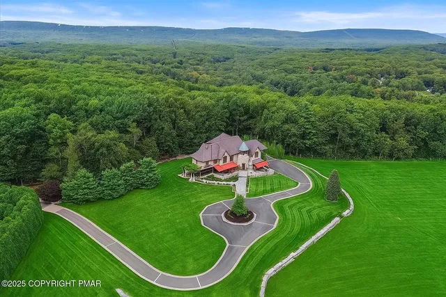 a kitchen with kitchen island granite countertop a sink stainless steel appliances and cabinets