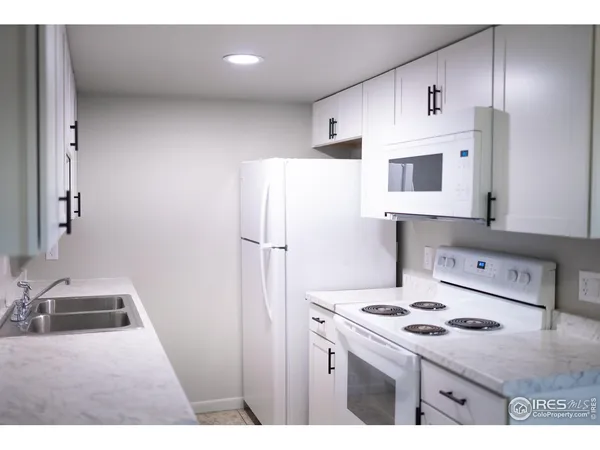 a kitchen with stainless steel appliances a stove a sink and a refrigerator