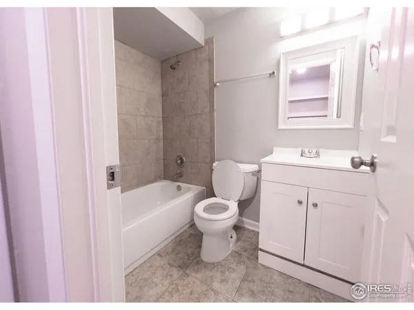 a bathroom with a sink toilet vanity and tub