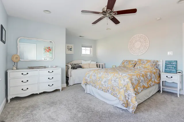 a spacious bedroom with a bed and a dresser