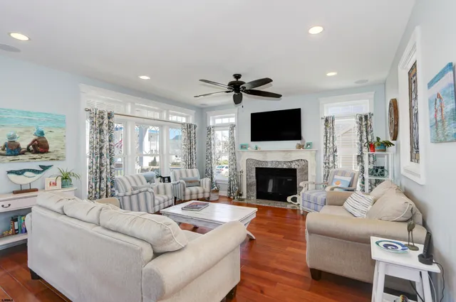 a living room with furniture a fireplace and a flat screen tv