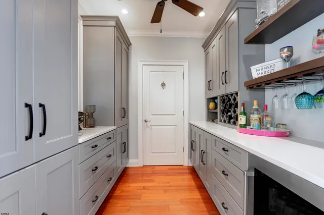 a kitchen with white cabinets and sink