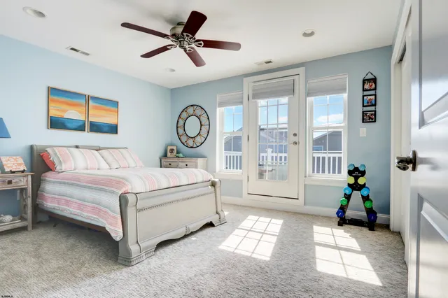 a bedroom with a bed a bookshelf and a window