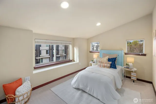 a spacious bedroom with a bed and a couch