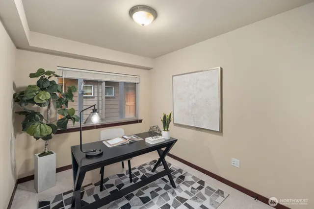 a living room with furniture and a potted plant