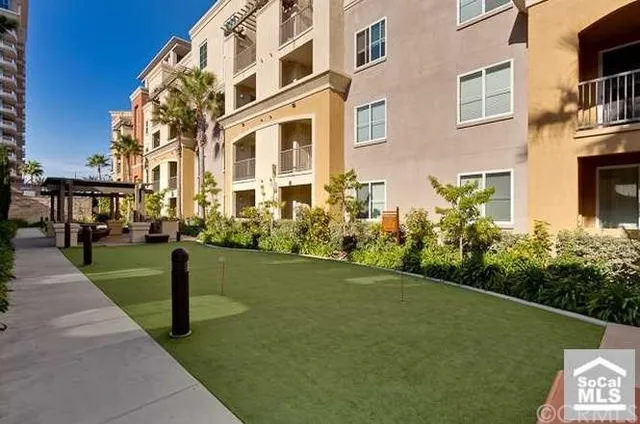 a front view of a building with a garden
