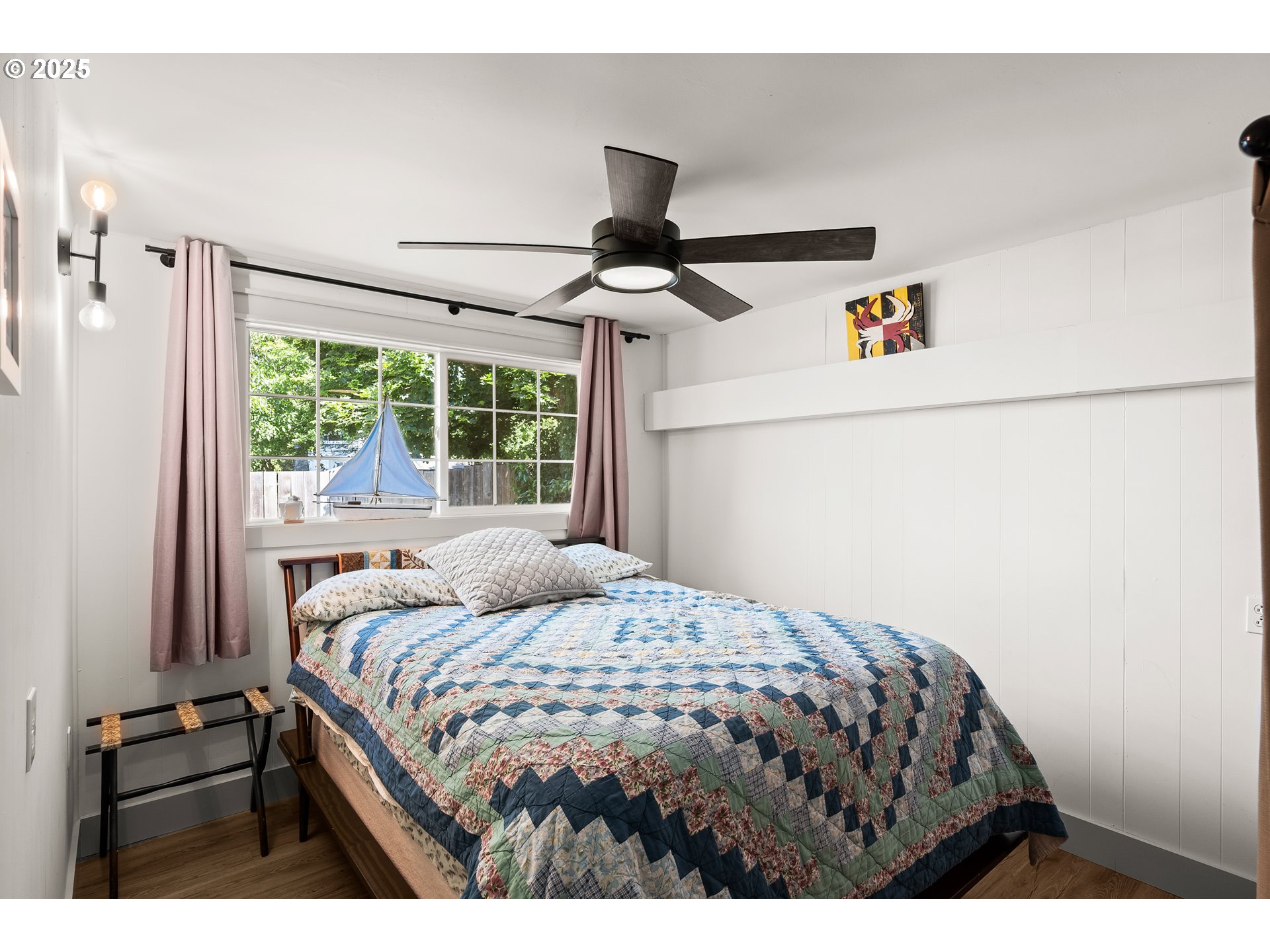 22692 Southwest Highland Drive Sherwood, OR 97140 - Photo 14 of 26 a bedroom with a bed and a chandelier