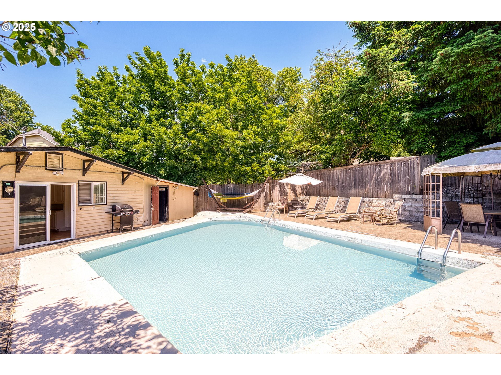 22692 Southwest Highland Drive Sherwood, OR 97140 - Photo 20 of 26 a swimming pool with outdoor seating and yard
