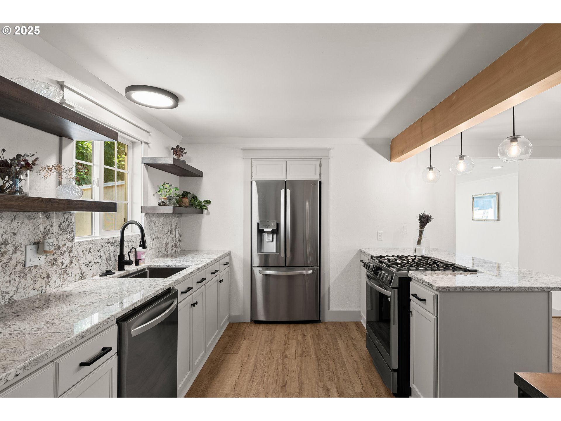 22692 Southwest Highland Drive Sherwood, OR 97140 - Photo 4 of 26 a kitchen with granite countertop a sink stainless steel appliances and cabinets