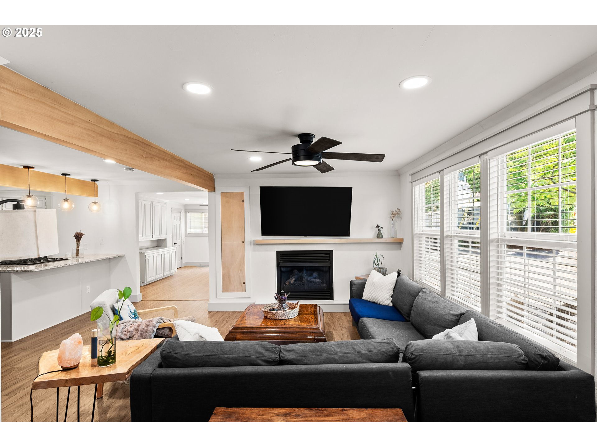 22692 Southwest Highland Drive Sherwood, OR 97140 - Photo 8 of 26 a living room with furniture a fireplace and a flat screen tv
