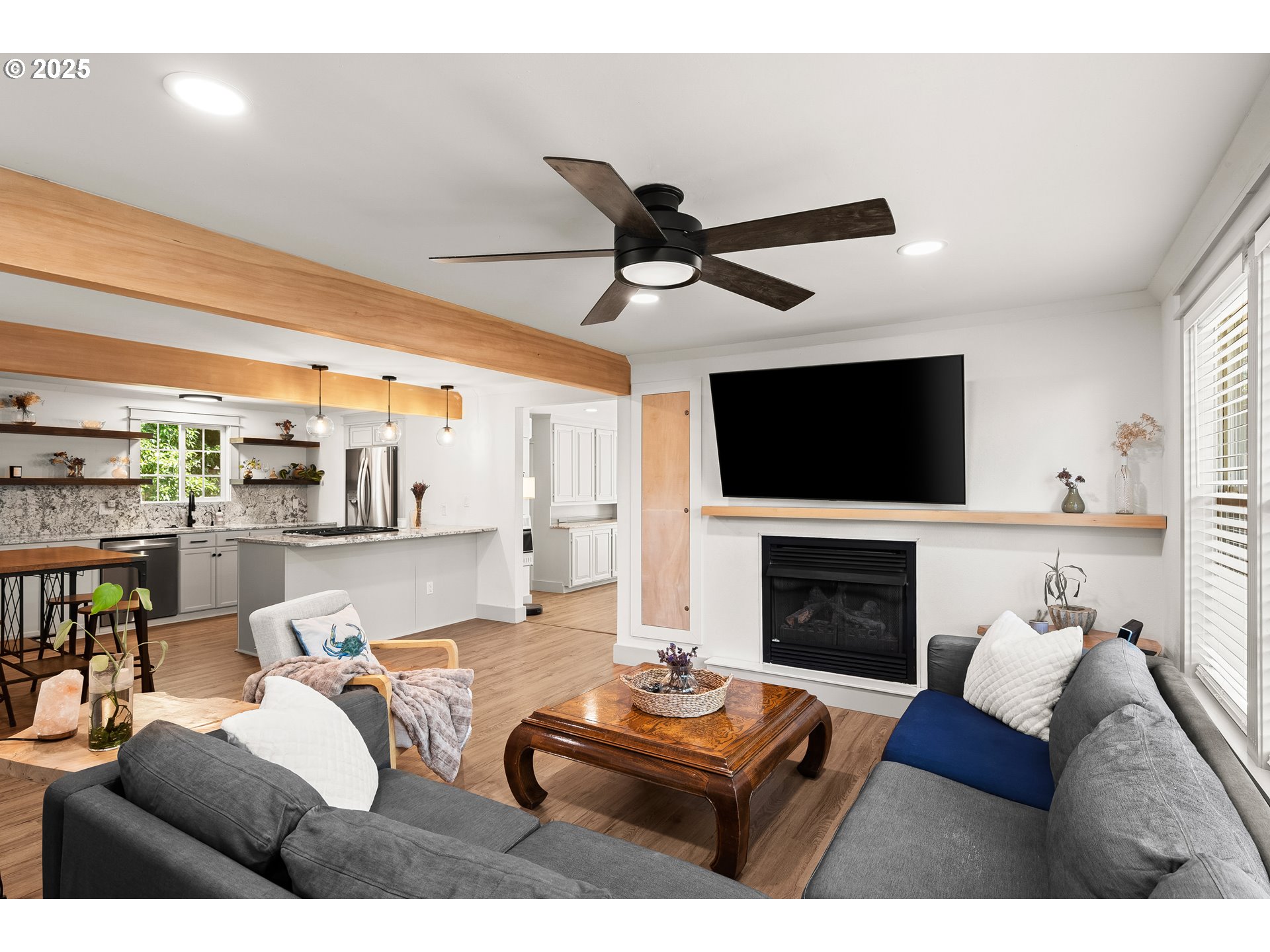 22692 Southwest Highland Drive Sherwood, OR 97140 - Photo 9 of 26 a living room with furniture a flat screen tv and a fireplace