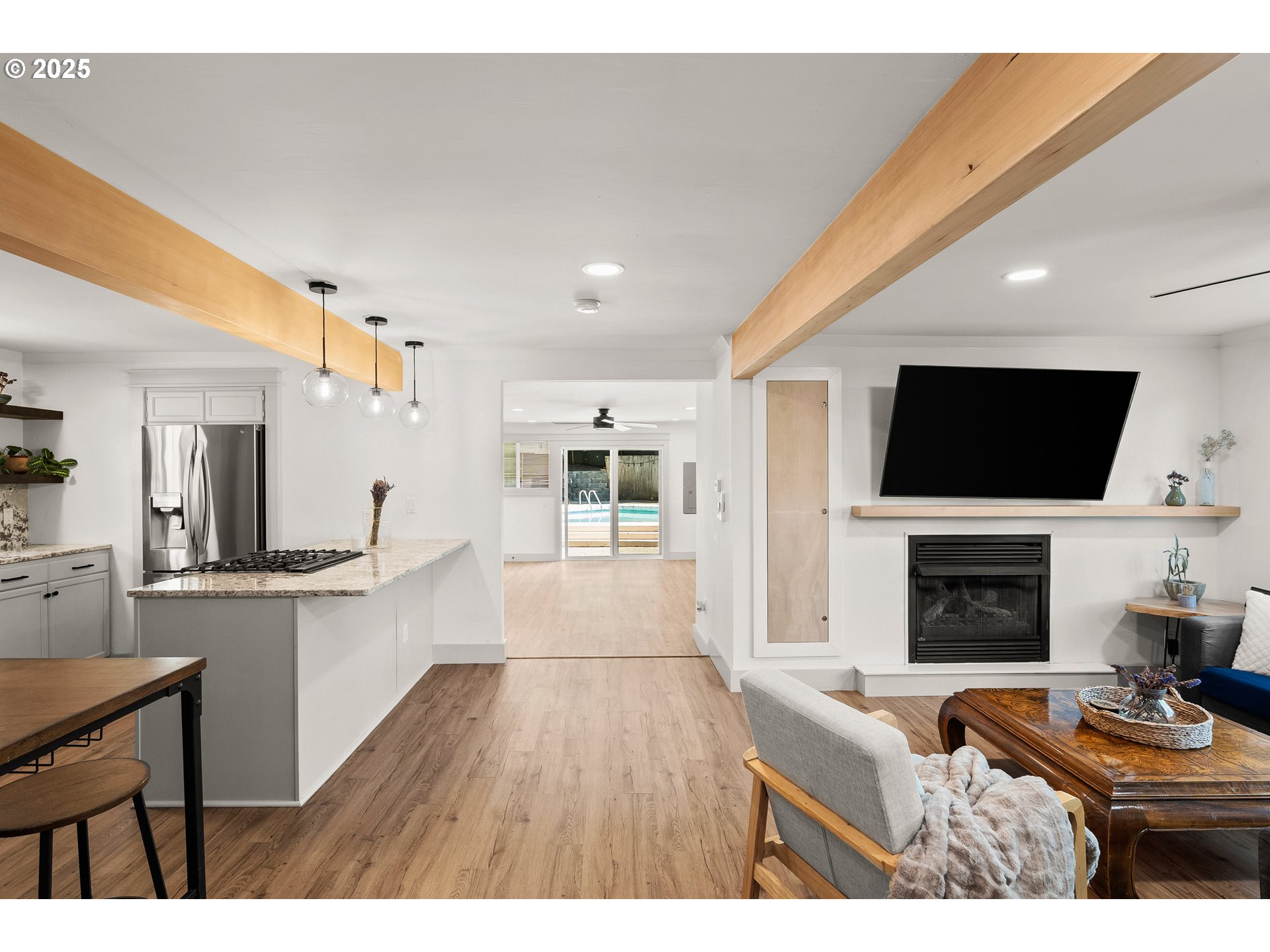 22692 Southwest Highland Drive Sherwood, OR 97140 - Photo 10 of 26 a living room with furniture a flat screen tv and a fireplace