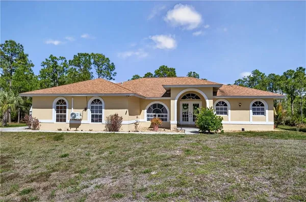 a front view of a house with a yard