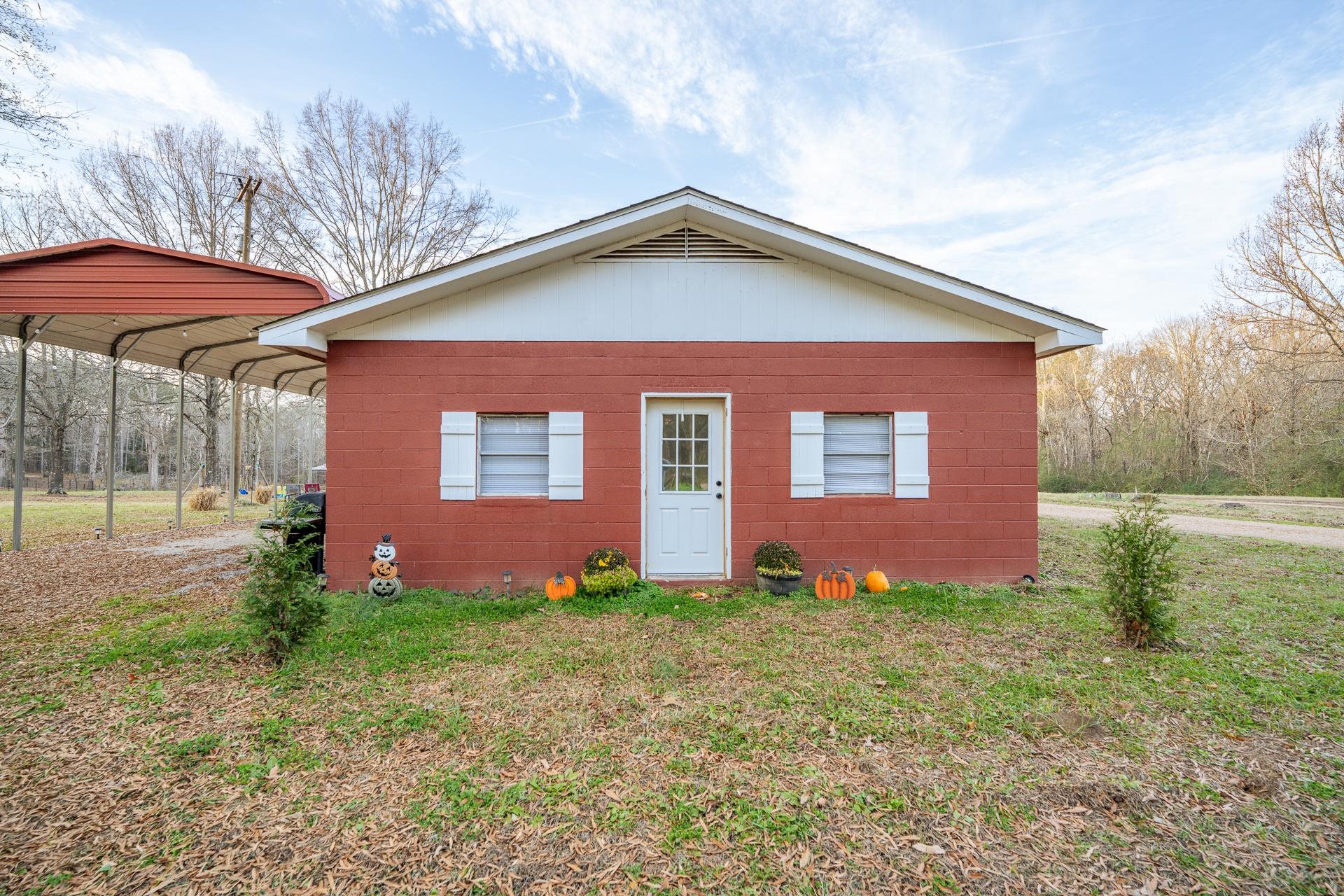 390 Woods Road Adamsville, TN 38310 - Photo 1 of 40 a view of front of a house with a yard