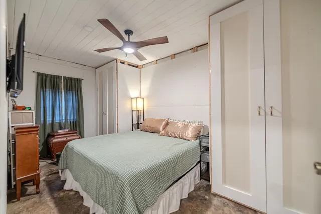 a bedroom with a bed and a chandelier