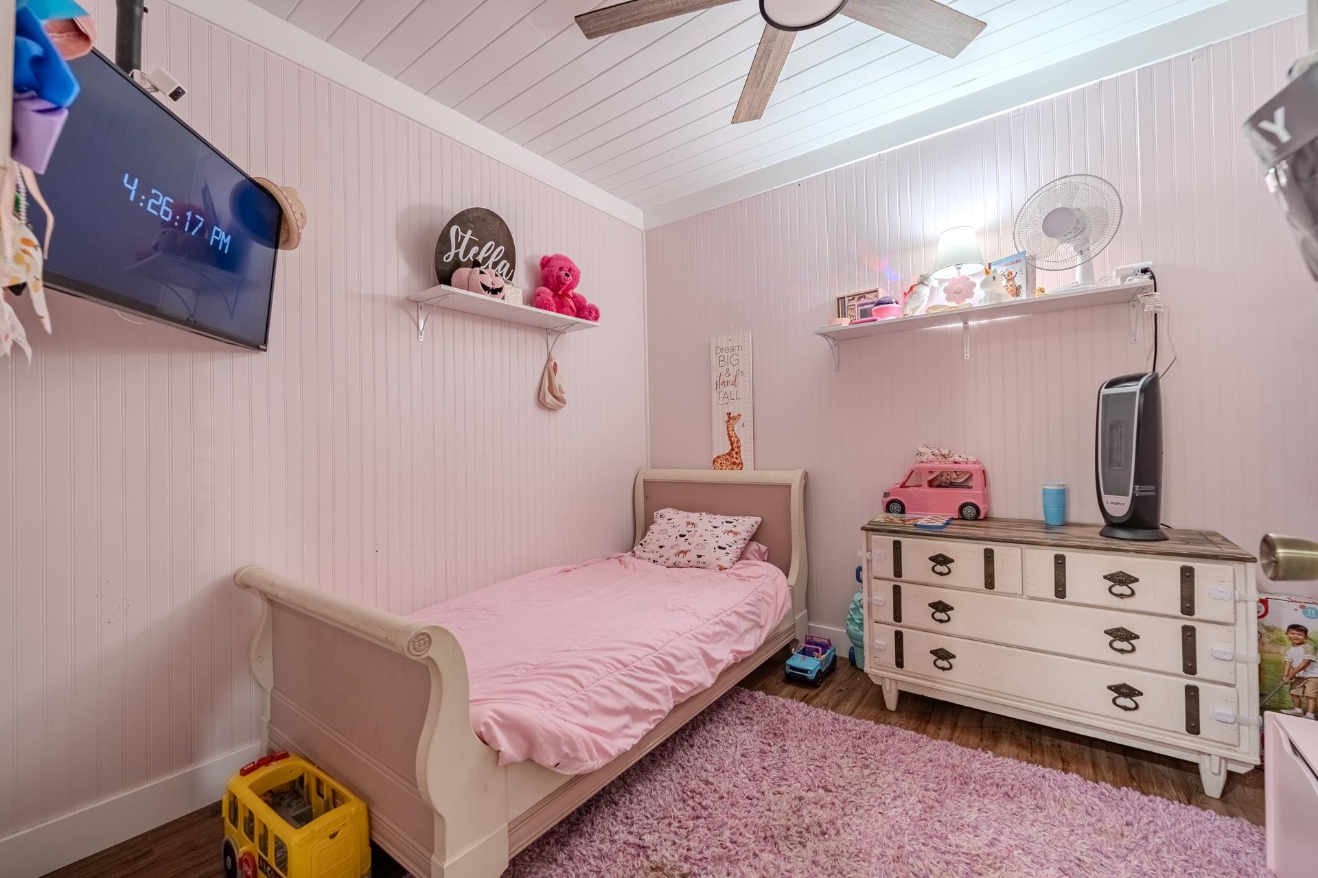 390 Woods Road Adamsville, TN 38310 - Photo 16 of 40 a bedroom with a bed and a chandelier