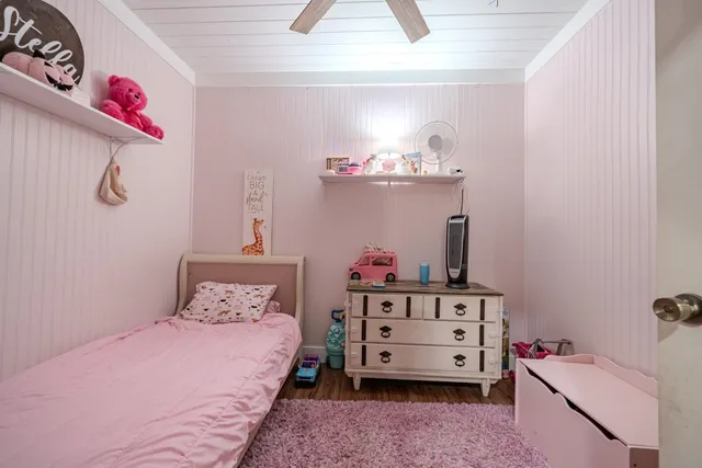 a bedroom with a bed and dresser