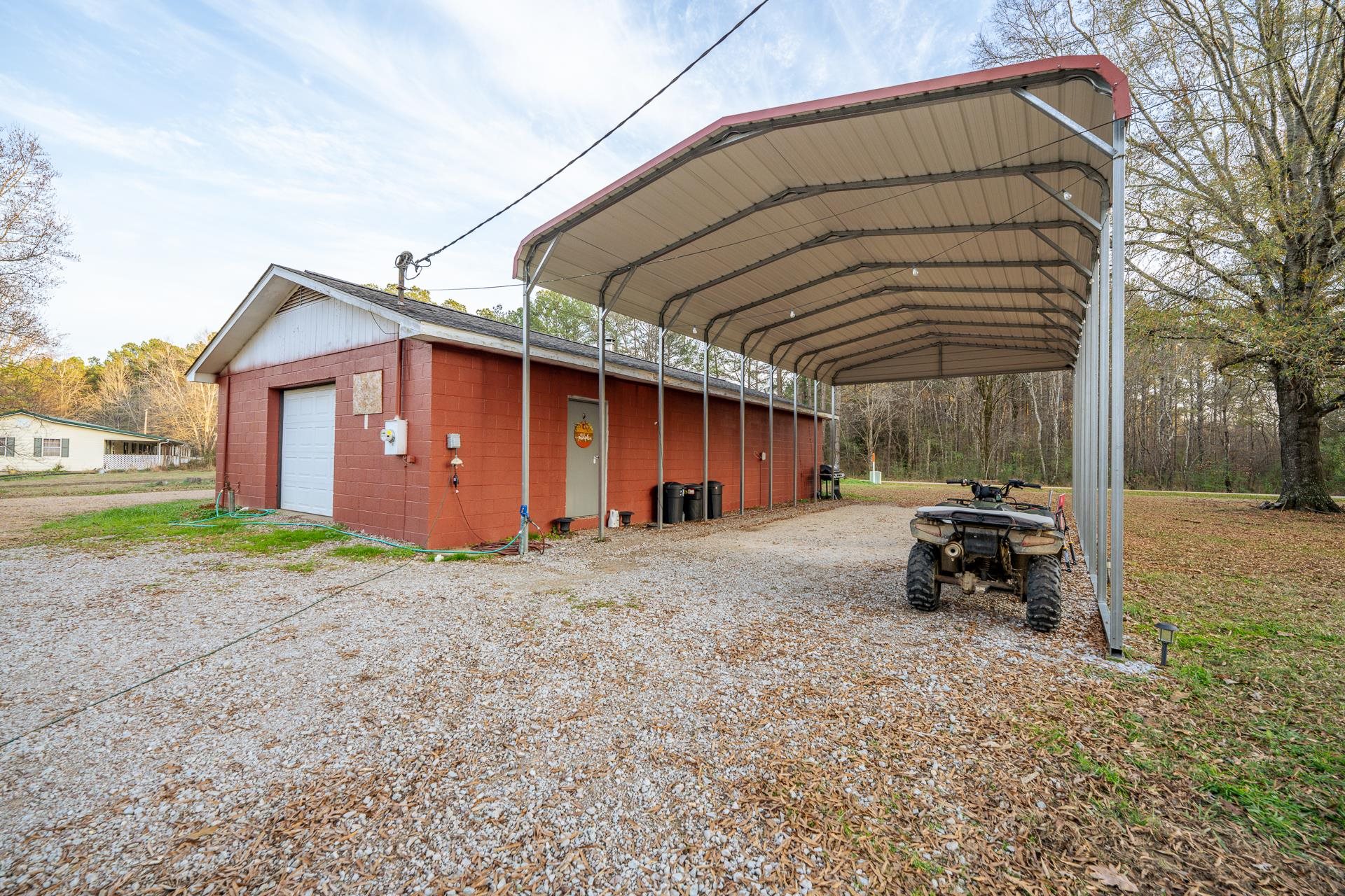 390 Woods Road Adamsville, TN 38310 - Photo 21 of 40 a backyard of a house with table and chairs