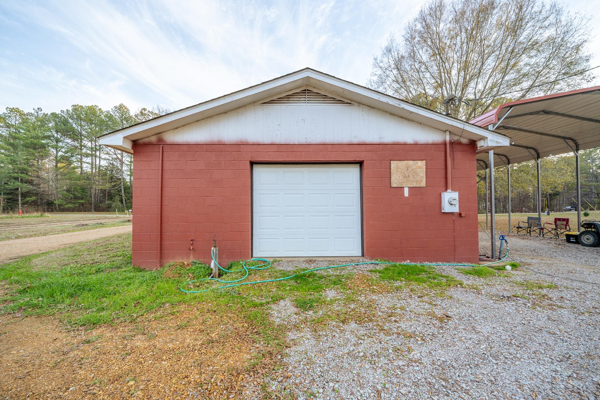 390 Woods Road Adamsville, TN 38310 - Photo 23 of 40 a front view of house with yard and trees all around
