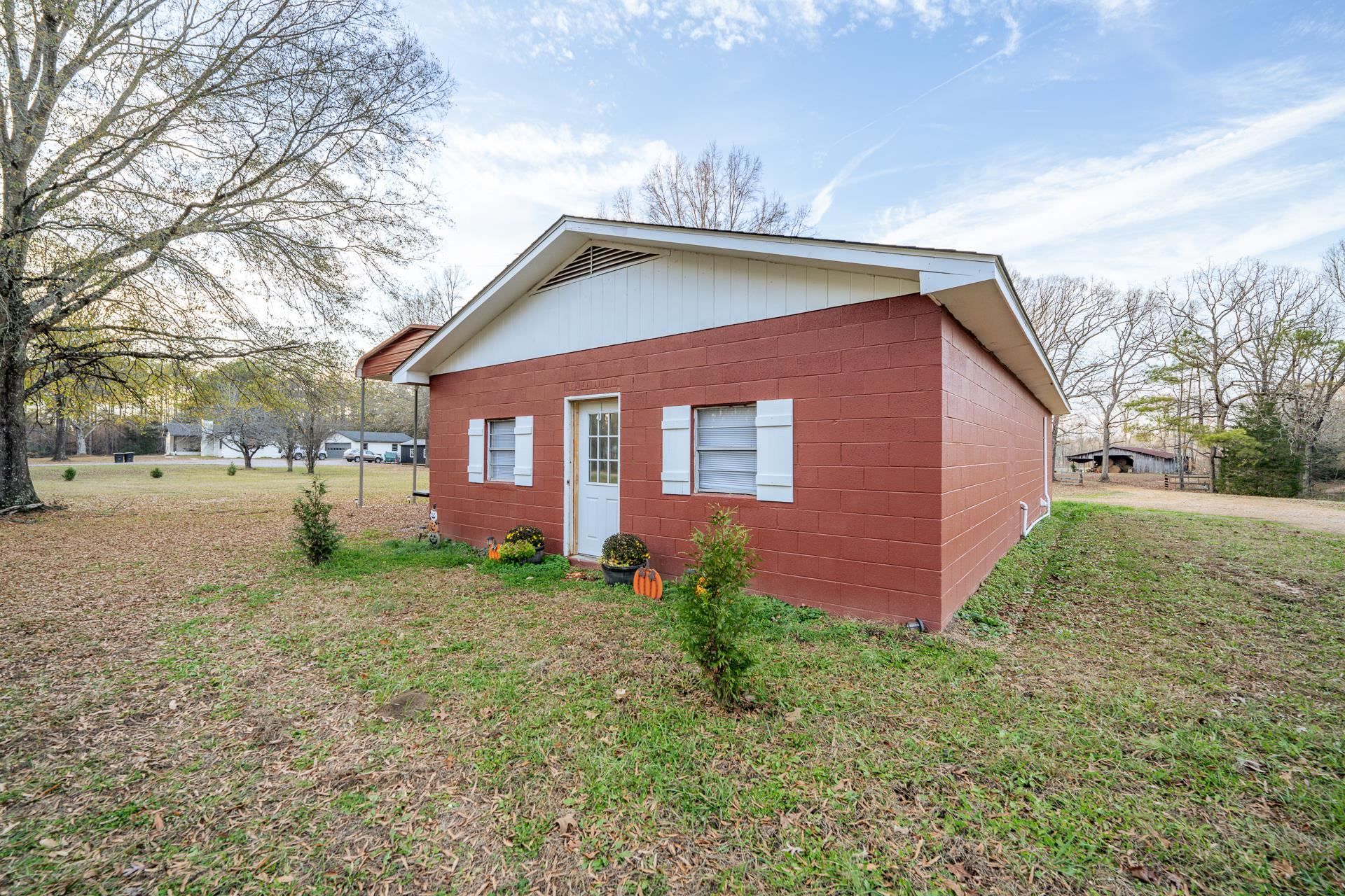 390 Woods Road Adamsville, TN 38310 - Photo 24 of 40 a view of a house with a yard