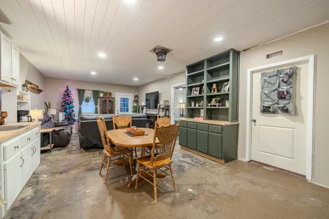 a view of a dining room with furniture and window