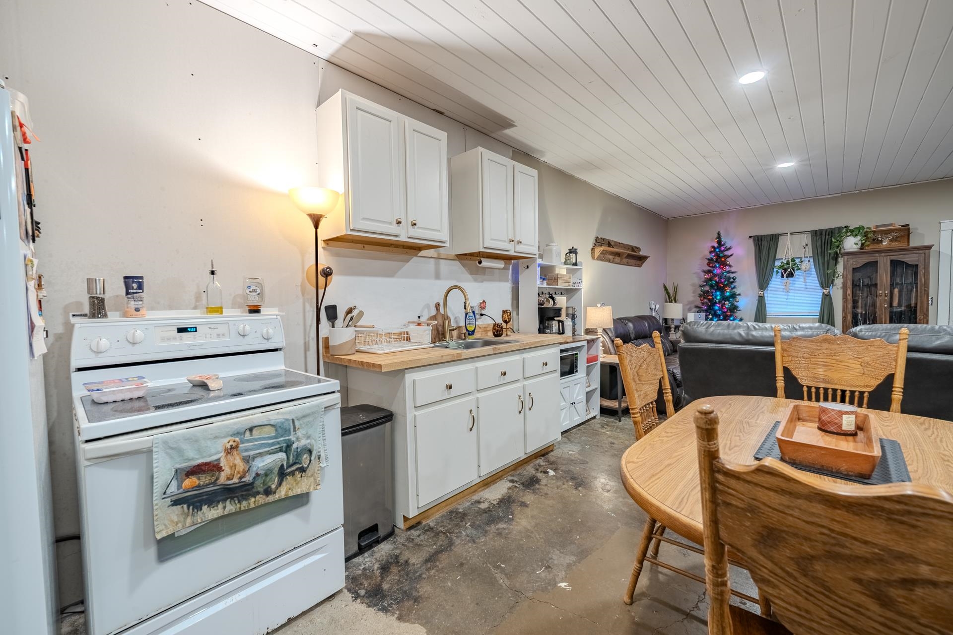 390 Woods Road Adamsville, TN 38310 - Photo 4 of 40 a kitchen with a stove and white cabinets