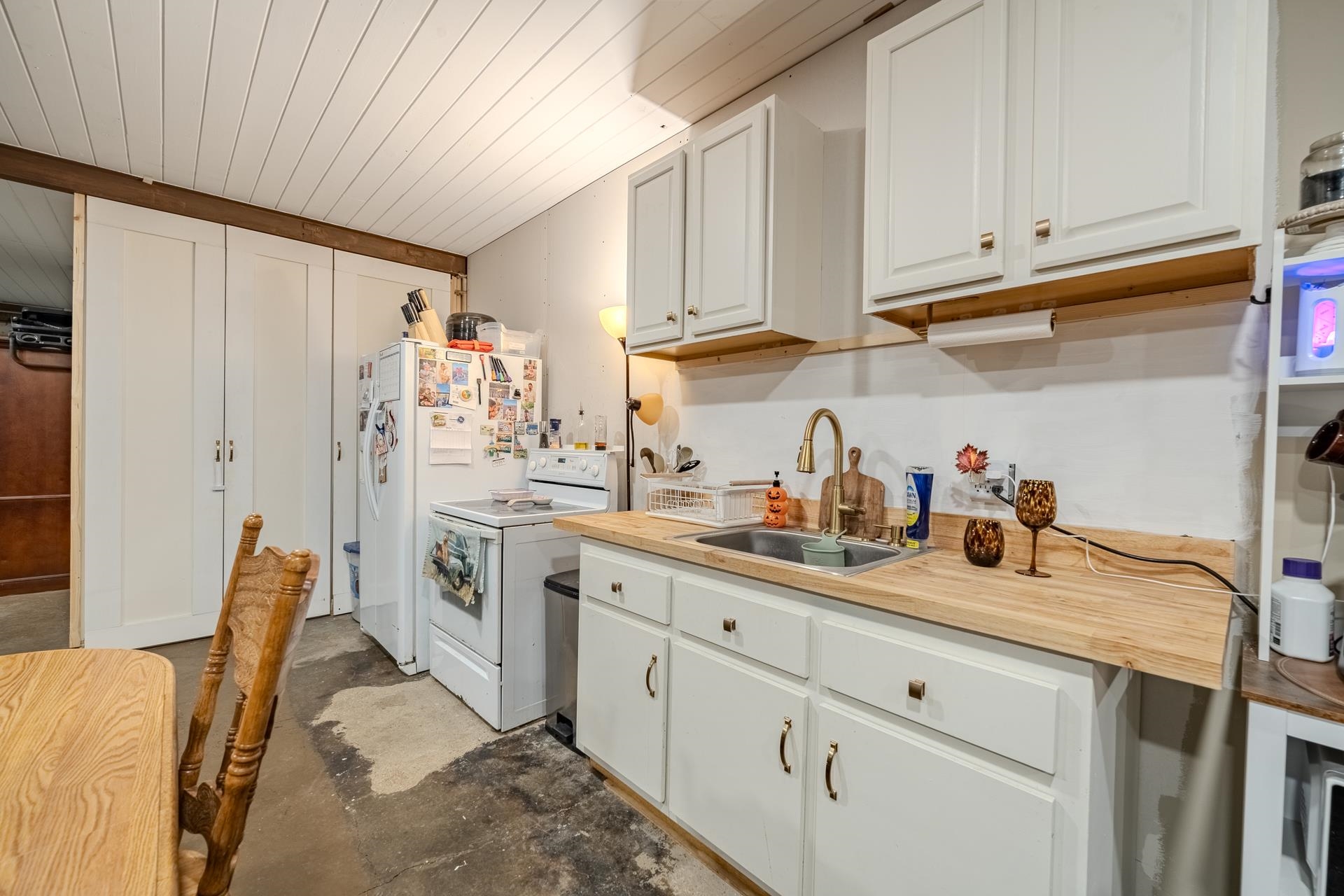 390 Woods Road Adamsville, TN 38310 - Photo 5 of 40 a kitchen with stainless steel appliances granite countertop a refrigerator sink and white cabinets